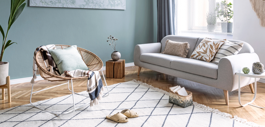 Séjour scandinave moderne et lumineux avec canapé scandinave gris, coussins et chaise ergonomique ovale en bambou